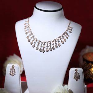 a white mannequin with a necklace and earrings on it