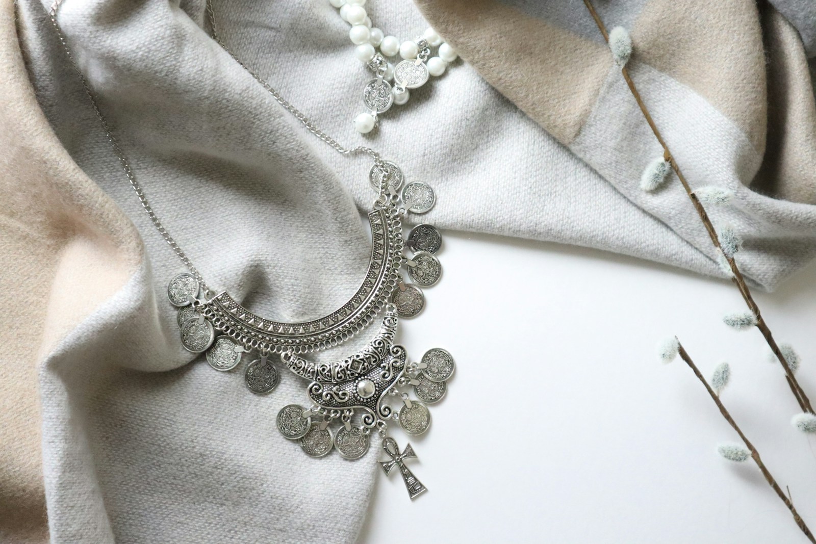 a close up of a necklace on a white surface