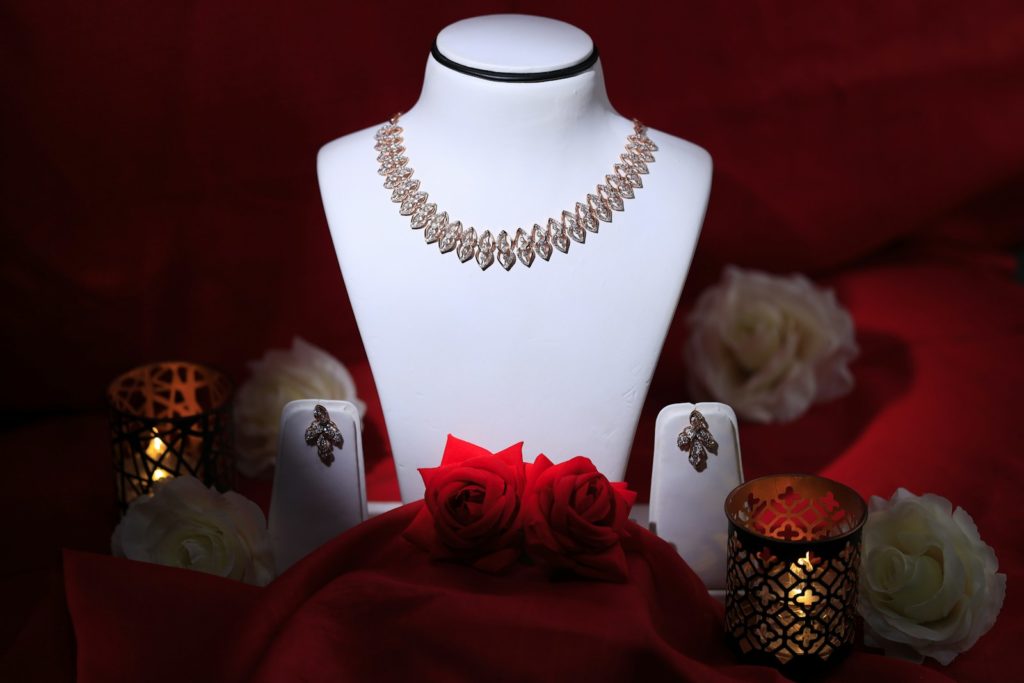 a white mannequin with a red rose on it