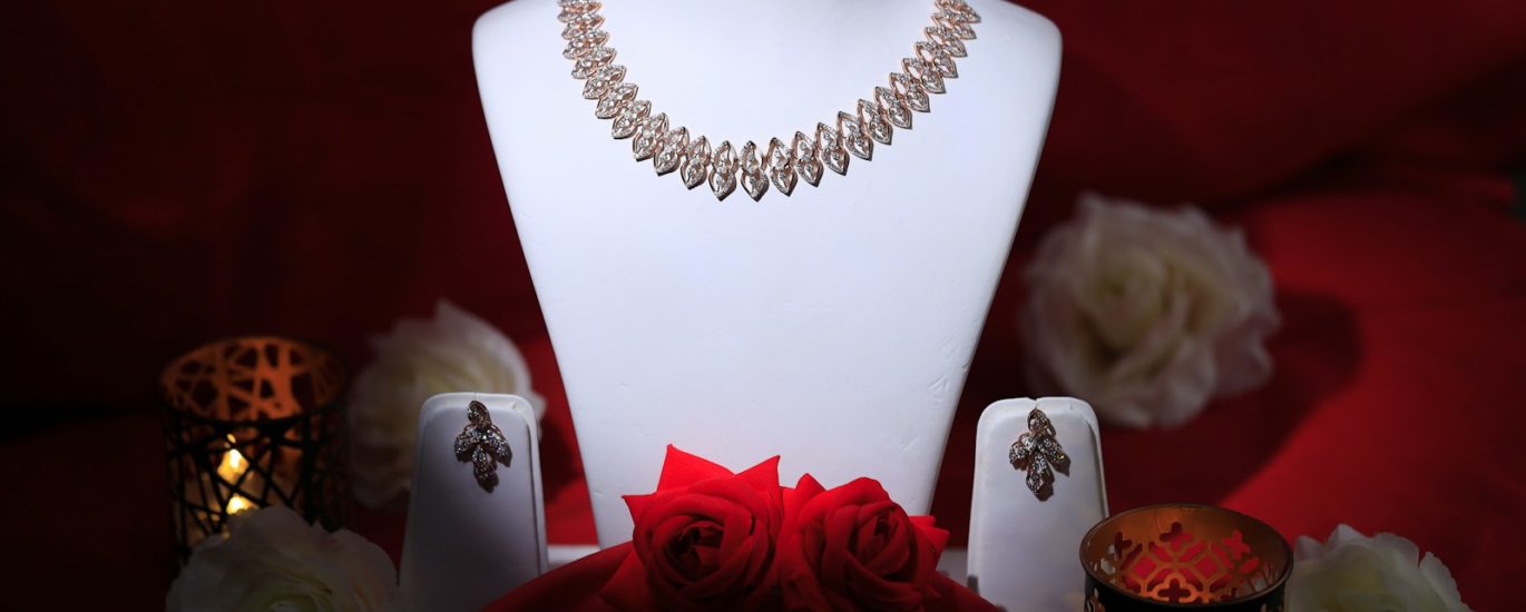 a white mannequin with a red rose on it