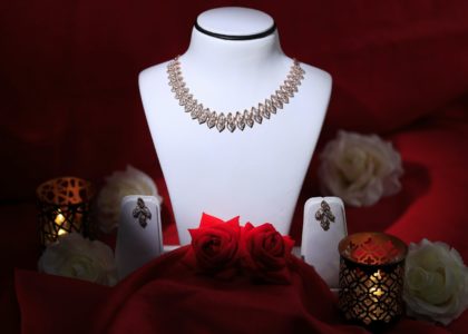 a white mannequin with a red rose on it