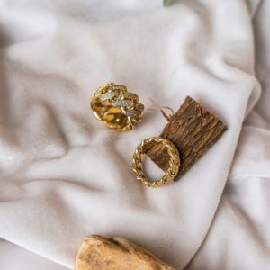 a couple of rings sitting on top of a white cloth